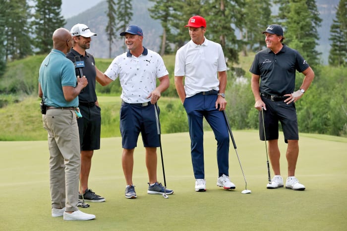 Aaron Rodgers, Bryson Dechambeau, Tom Brady and Phil Mickelson stand to be interviewed at their golf match.